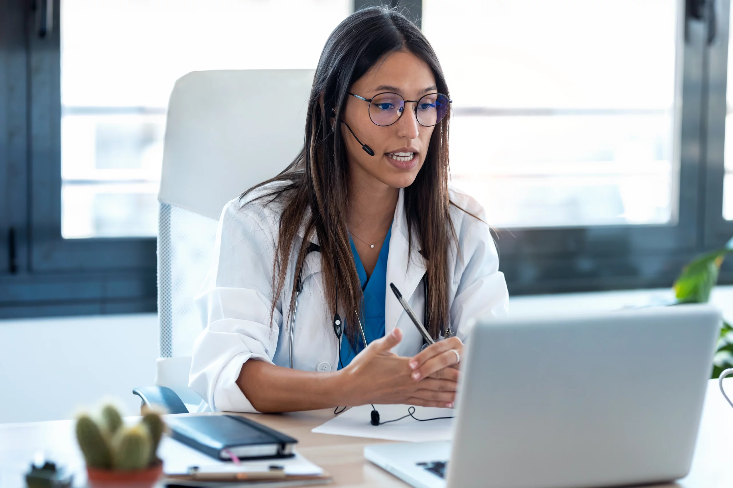 Doctor speaking with patient through laptop